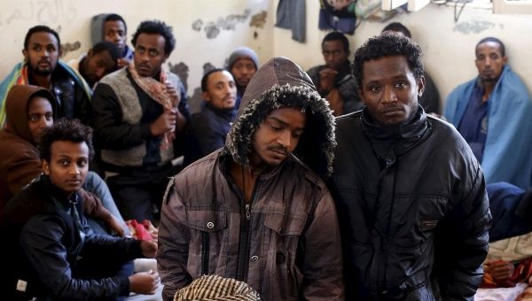 Illegal migrants stand in an immigration holding center located on the outskirts of Misrata March 11, 2015.