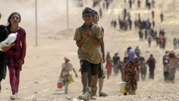 Survival first, schooling second ... Children from the minority Yazidi sect flee Islamic State militants in Sinjar, Iraq, in 2014.