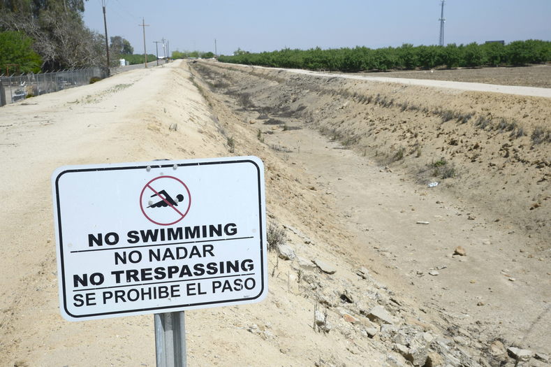 A sign reading 'No Swimming' is posted next to a dried up irrigation canal near Fresno, California, USA, 10 April 2015, in the Central Valley.