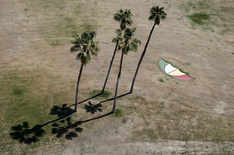 An umbrella is seen painted on dry grass in the Palm Springs area, California April 13, 2015.