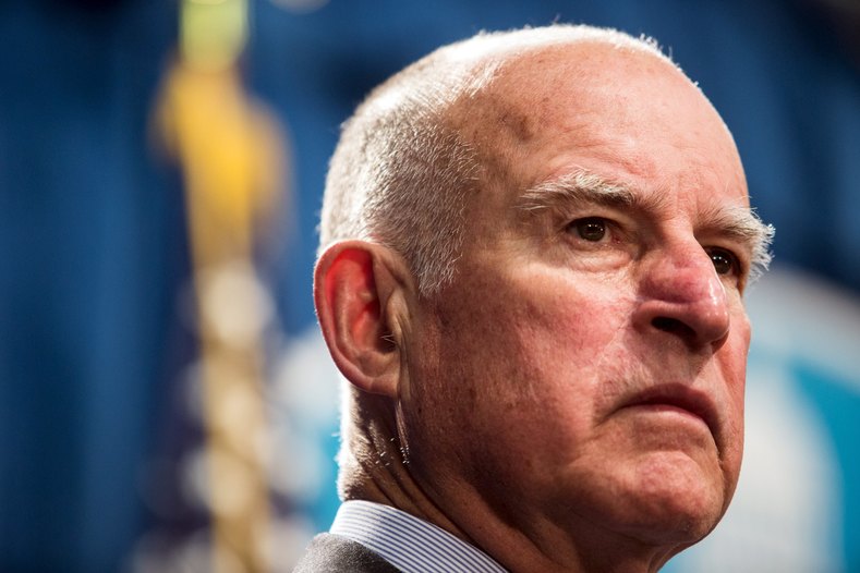 California Governor Jerry Brown looks on during a news conference at the State Capitol in Sacramento, California March 19, 2015, to announce a US$1 billion emergency legislative package to deal with the state's devastating, multiyear drought. The state is entering a fourth year of record-breaking drought that has prompted officials to sharply reduce water supplies to farmers and impose strict conservation measures statewide.