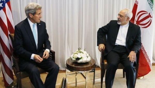 US Secretary of State John Kerry, left, talks with Iranian Foreign Minister Mohammad Javad Zarif on Jan. 14 before a meeting in Geneva.