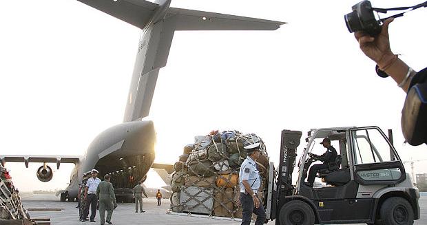 Members of India's National Disaster Response Force (NDRF) prepare relief materials to be airlifted to Nepal to provide assistance to victims.