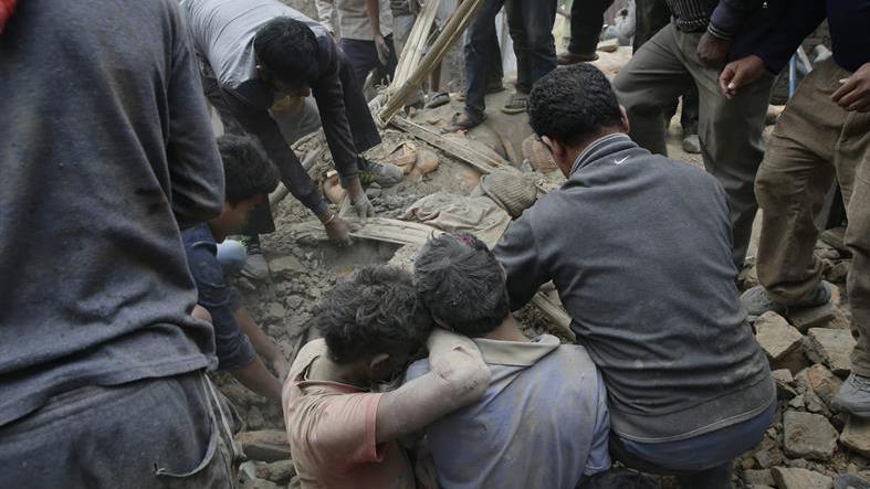 People try to dig out bodies from under the rubble of a destroyed building after an earthquake hit Nepal, in Kathmandu.
