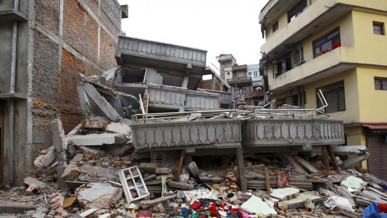 A collapsed building is pictured after an earthquake hit, in Kathmandu, Nepal April 25, 2015. The shallow earthquake measuring 7.9 magnitude struck west of the ancient Nepali capital of Kathmandu.