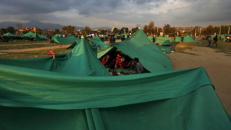 People in Napal sit in their makeshift tents after their homes were destroyed after recent earthquakes left thousands homeless.