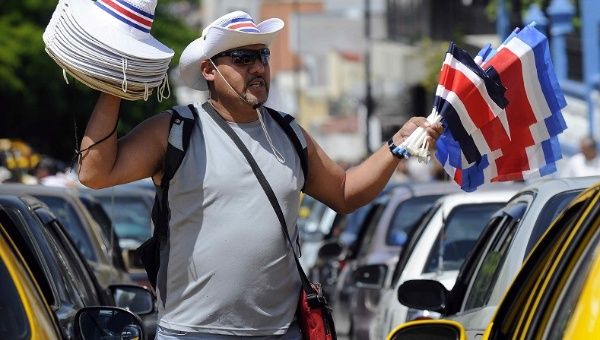 A man sells traditional hats and flags in San Jose, Costa Rica.