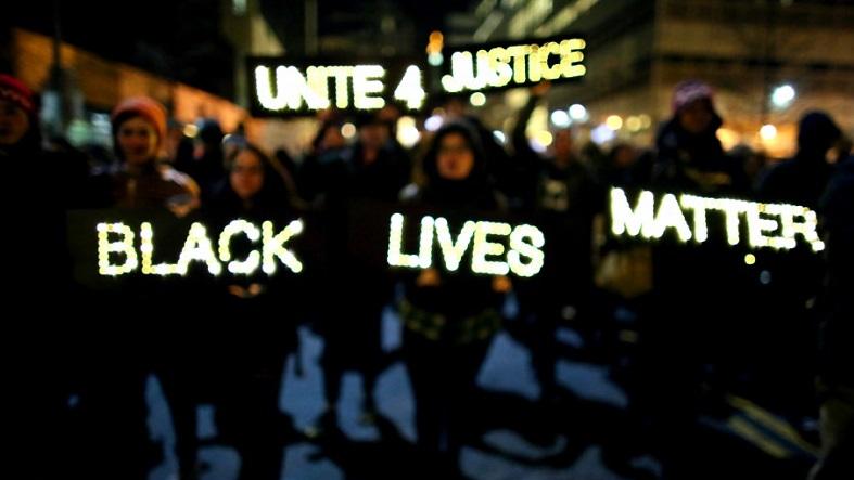 Demonstrators carry illuminated signs in a Black Lives Matter march in December 2014 in New York.