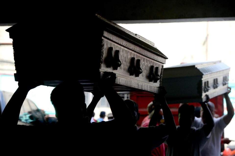 A makeshift morgue was set up in a village hall in Valenzuela City for the victims of the recent factroy fire.
