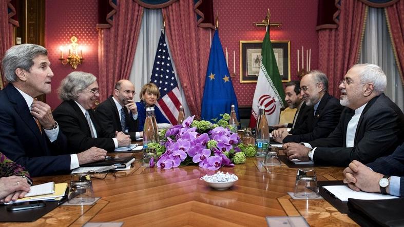 U.S. Secretary of State John Kerry (L), U.S. Secretary of Energy Ernest Moniz (2nd L), Head of the Iranian Atomic Energy Organisation Ali Akbar Salehi (2nd R) and Iranian Foreign Minister Javad Zarif (R) wait with others ahead of a meeting at the Beau Rivage Palace Hotel in Lausanne on March 26, 2015.