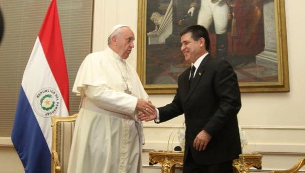 Pope Francis (L) is greeted by Paraguayan President Horacio Cartes