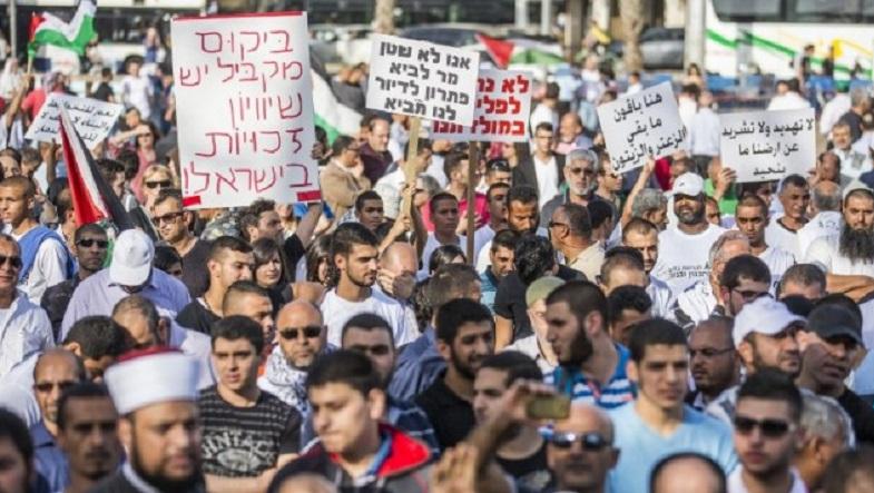 Arab Israelis take part in a rally organized by the High Follow-Up Committee for Arab Citizens of Israel, in protest against the demolition of homes in Arab communities, at Rabin Square, Tel Aviv, April 28, 2015.