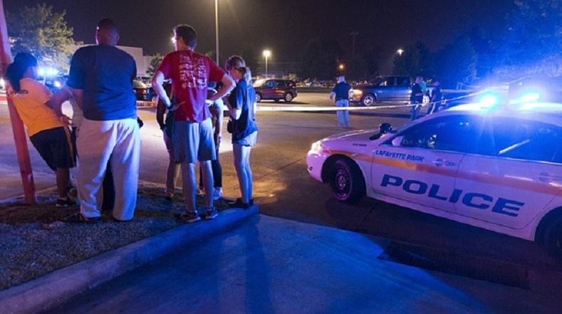 Bystanders watch over the scene at the Grand movie theater in Lafayette, United States.