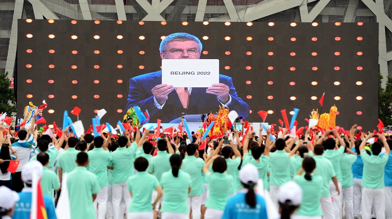 People cheer as they watch on a screen the IOC announcing Beijing as the winner city for the 2022 winter Olympics bid, outside the Birds' Nest, also known as the National Stadium, in Beijing, China, July 31, 2015.