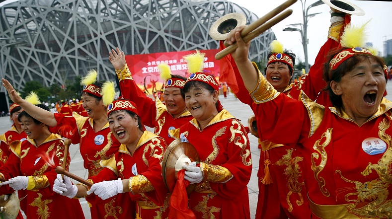 Performers cheer ahead of IOC's announcement of the winner city for the 2022 winter Olympics bid, outside the Birds' Nest, also known as the National Stadium, in Beijing, China, July 31, 2015.