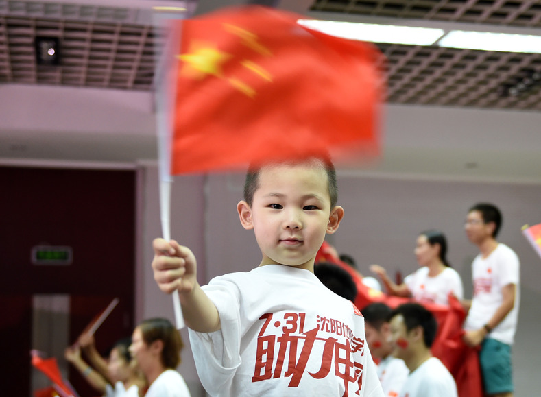 A child waves a flag, July 31, 2015.