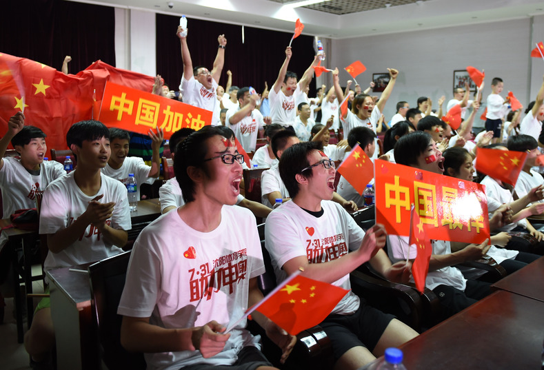 Students and teachers from the Sports University of Shenyang celebrate the Winter Olympics victory, Liaoning province, July 31, 2015.