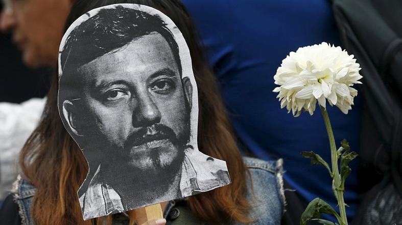 MEXICO CITY: An activist holds up a picture of photojournalist Ruben Espinosa during a protest against his murder at the Angel of Independence monument, Aug. 2, 2015.