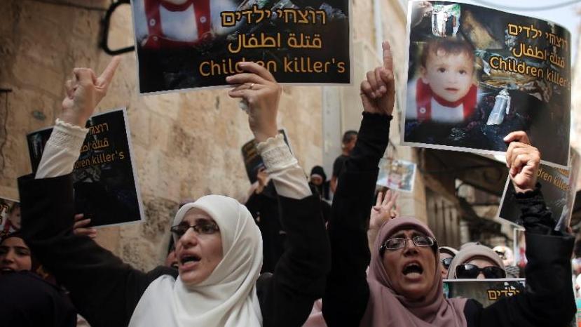 Palestinians take part in a protest against the death of the 18-month-old child killed in an arson attack in the occupied West Bank, on August 2, 2015.