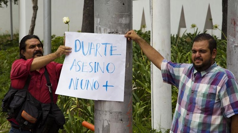 Journalists in Guadalajara, Mexico, hold a banner reading 