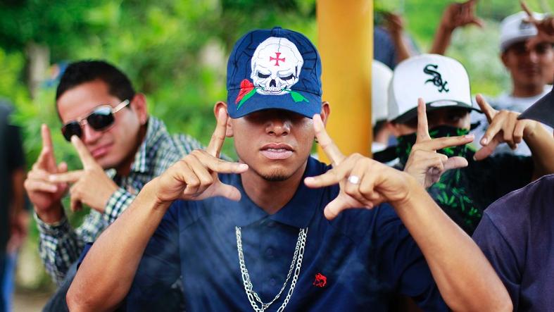 Gang members in El Salvador flash gang symbols.