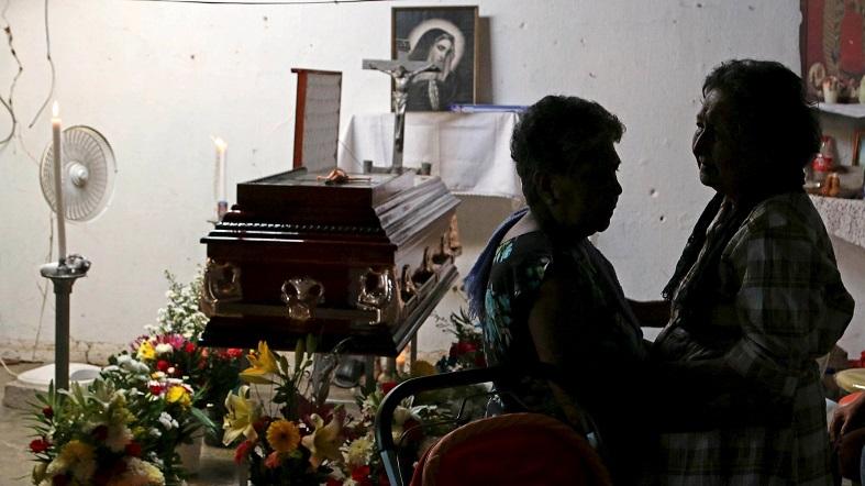 Relatives gather near the casket of Miguel Angel Jimenez during his wake in Xaltianguis in the state of Guerrero, August 9, 2015.