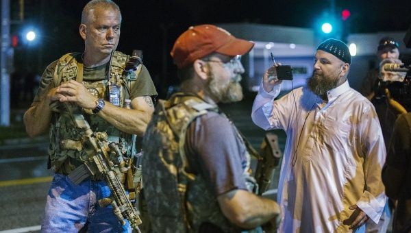 Heavily armed members of the Oath Keepers militia patrol the streets of Ferguson.