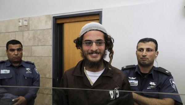 Far-right activist Meir Ettinger (C) attends a remand hearing at the Magistrates Court in Nazareth, Israel August 4, 2015. 