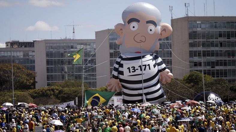 An inflatable doll of former President Luiz Inacio Lula da Silva can be seen during a protest against Brazil's President Dilma Rousseff, part of nationwide protests calling for her impeachment, at Esplanade of Ministries in Brasilia, Brazil, August 16, 2015.