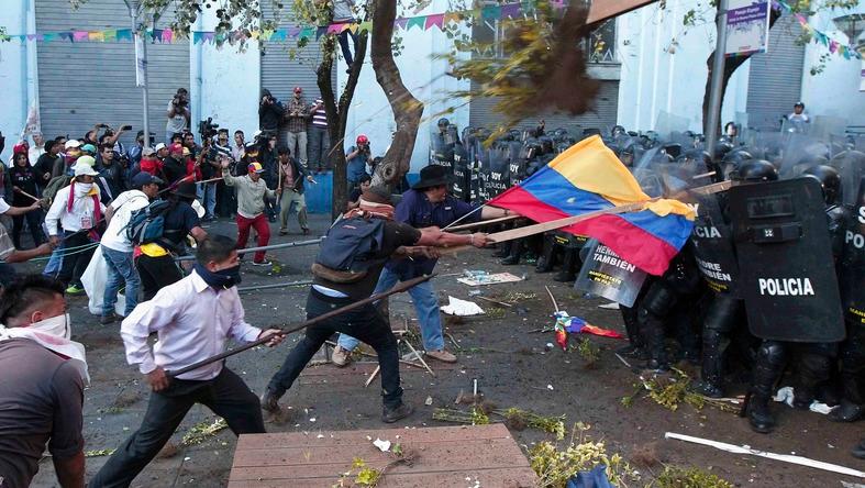 Protesters from opposition parties in Ecuador attack riot police in Quito on Aug. 19.