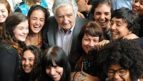 Jose Mujica is received by an overwhelming crowd of 5,000 students at State University of Rio de Janeiro