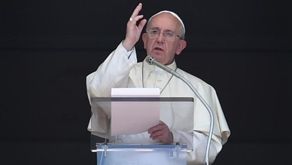 Pope Francis delivers his Sunday Angelus prayer from the window of the apostolic palace overlooking St Peter's Square in the Vatican on August 30, 2015.