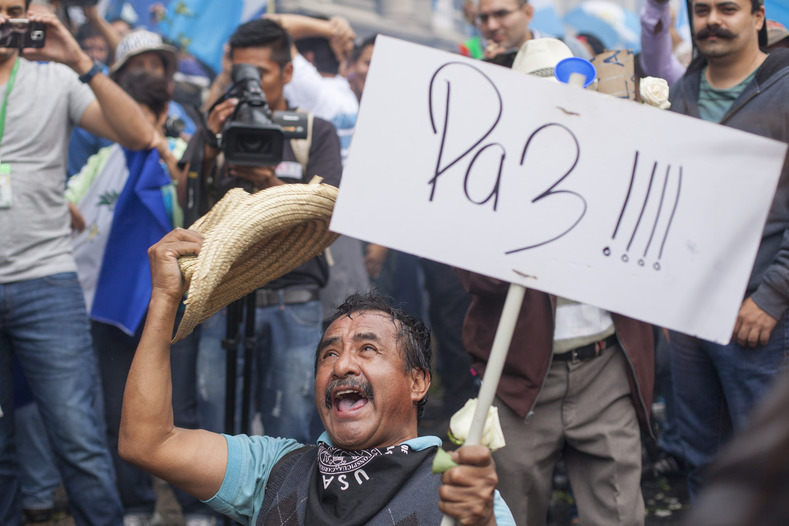 A man, holding a sign saying 