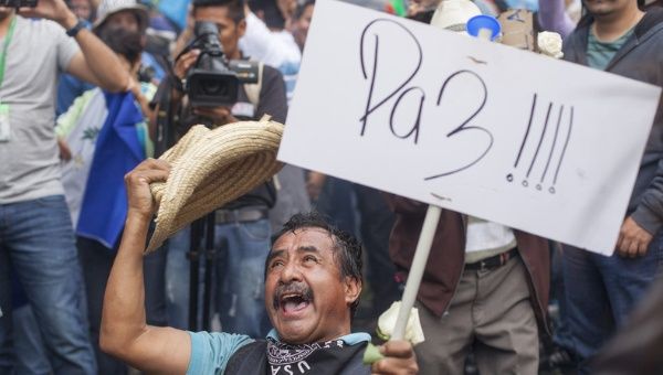 A man, holding a sign saying 