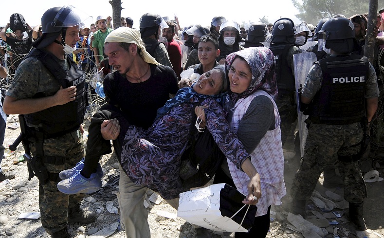 Refugees  rush to cross into Macedonia after Macedonian police allowed a small group of people to pass through a passageway, as they try to regulate the flow of migrants at the Macedonian-Greek border September 2, 2015.