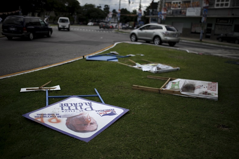 Campaign signs are pictured on the ground before Sunday's presidential election in Guatemala City, Guatemala September 5, 2015.