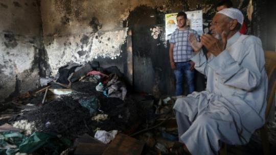 Palestinians inside the Dawabsheh home in Duma following an arson attack in July 31, 2014.