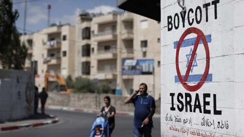 A sign painted on a wall in Bethlehem calling for a boycott of Israeli goods.