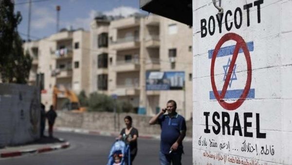 A sign painted on a wall in Bethlehem calling for a boycott of Israeli goods.