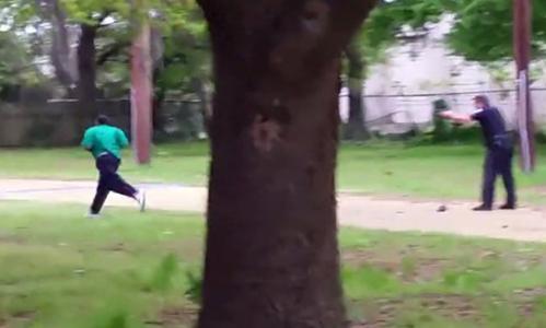 A screen shot of video showing a South Carolina police officer shooting Walter Scott in the back.