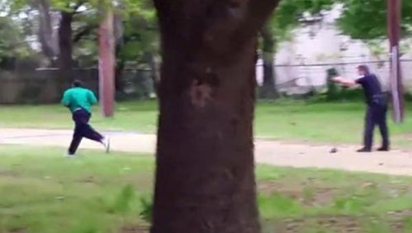 A screen shot of video showing a South Carolina police officer shooting Walter Scott in the back.