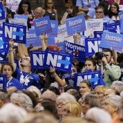 Supporters of U.S. Democratic presidential candidate Hillary Clinton and U.S. Senator Bernie Sanders hold signs in Manchester, New Hampshire, Sept. 19, 2015.