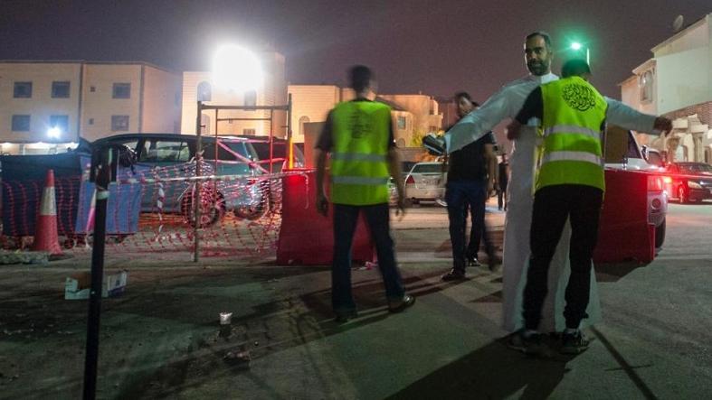 Saudi Shiite worshipers are frisked by members of security as they make their way to a Shiite hall used for commemorations, in Qatif on Oct. 16, 2015