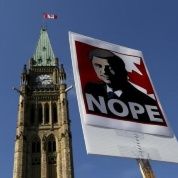  A sign featuring an illustration of Conservative leader and Canada's Prime Minister Stephen Harper is pictured during a singalong performance of 'Harperman,' a protest song against Harper, on Parliament Hill in Ottawa, Ontario September 17, 2015.