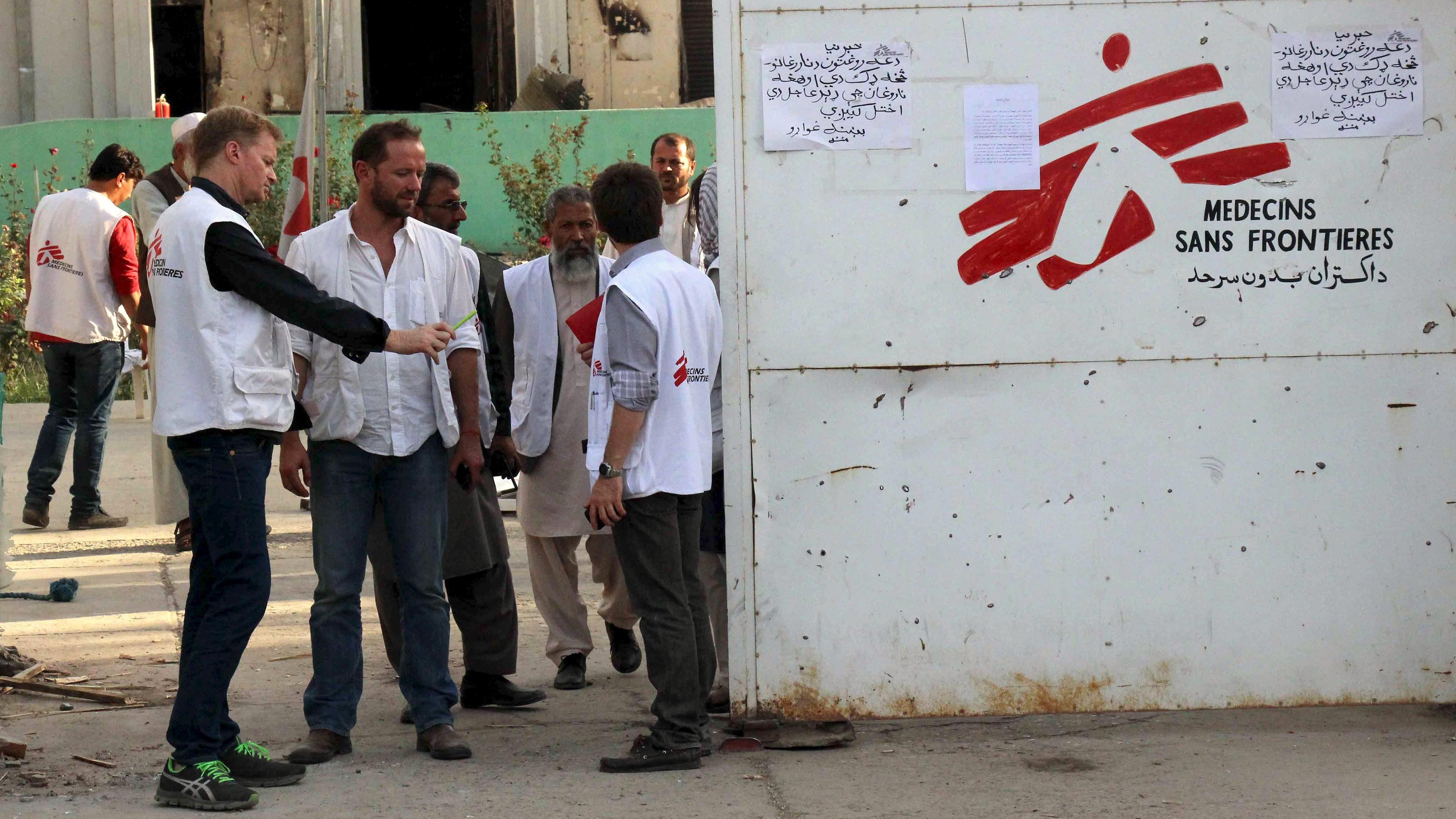 Christopher Stokes (front L), general director of Medecins Sans Frontieres (MSF), stands in front of an entrance gate of the MSF hospital in Kunduz, Afghanistan.