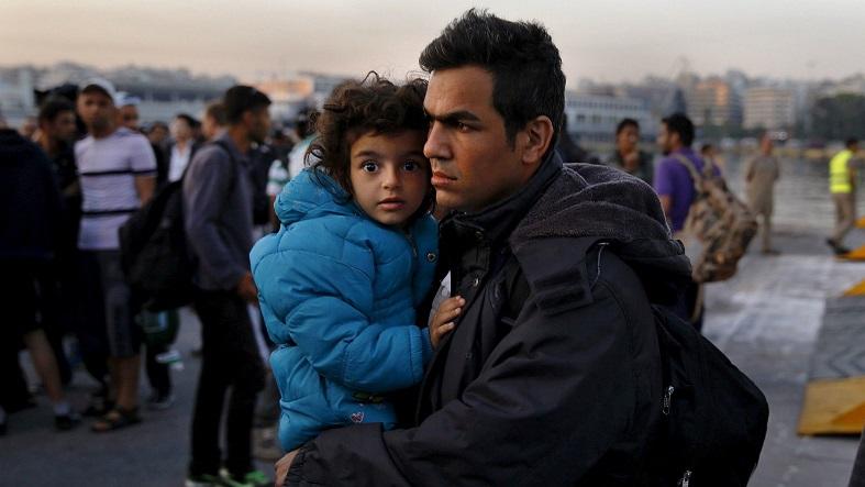 Syrian refugees disembark from a Greek ferry after arriving in the port of Piraeus near Athens.