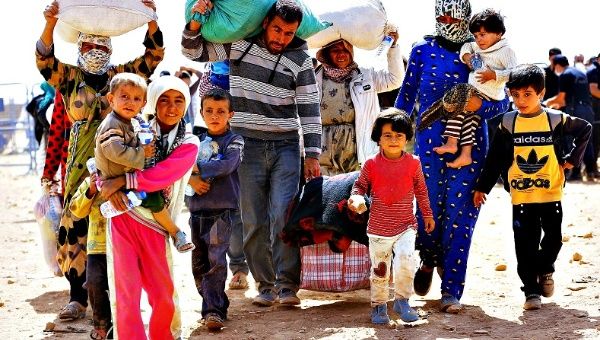 Kurdish Syrian refugees walk near the Turkish-Syrian border.