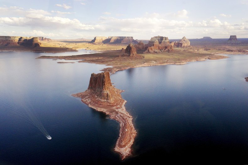 A boat makes its way around Padre Butte in Lake Powell.