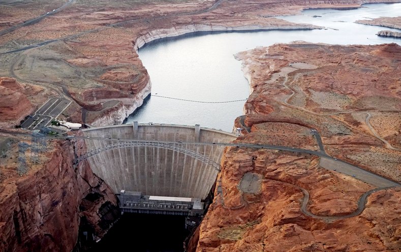 The Glen Canyon dam holds back the Colorado River creating Lake Powell. The lake provides water for Nevada, Arizona and California.