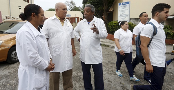 Doctors chat at the entrance of a hospital in Havana.